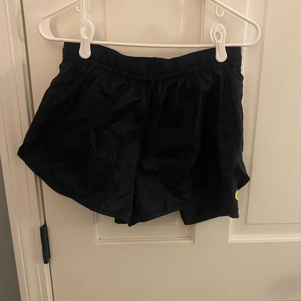 black nike sport shorts with neon yellow/green logo